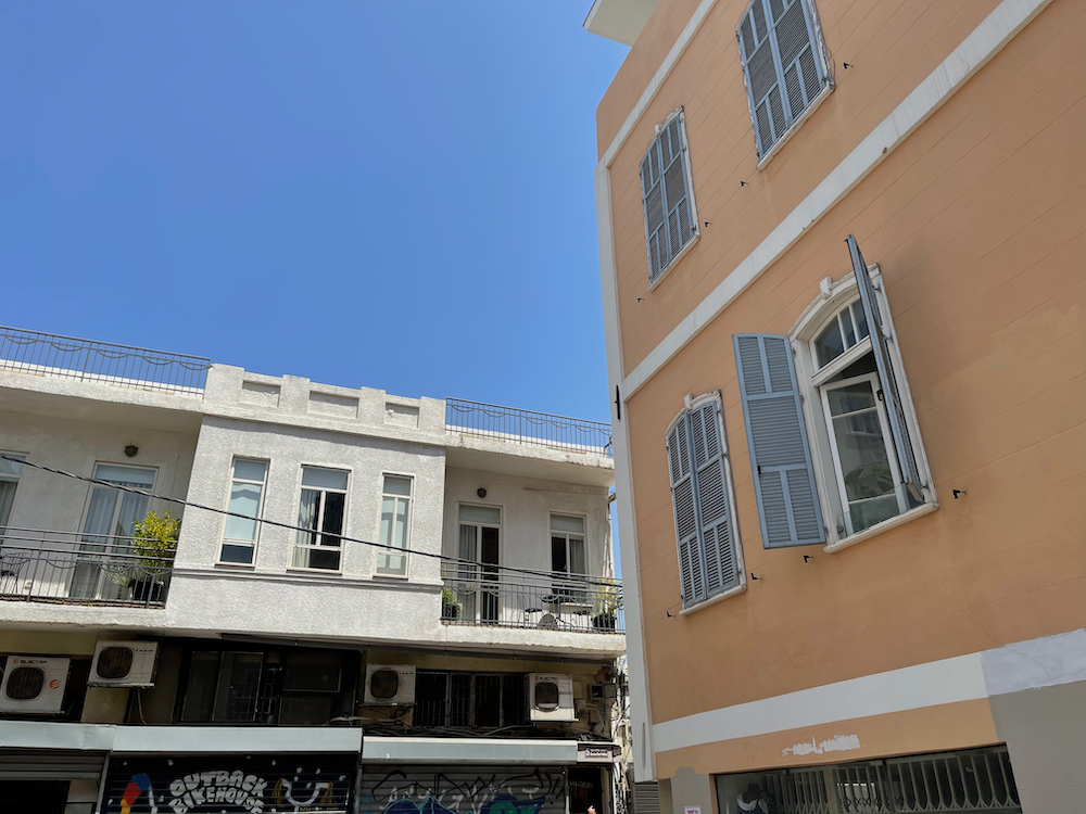 Two short buildings against a blue sky